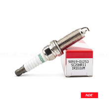Spark plug with packaging on a white background