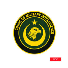 A circular emblem sticker featuring the Corps of Military Intelligence logo, with a yellow eagle head and crescent on a dark green background, surrounded by a black ring with yellow text, shown on a white background with an NDE brand label in the bottom right corner.