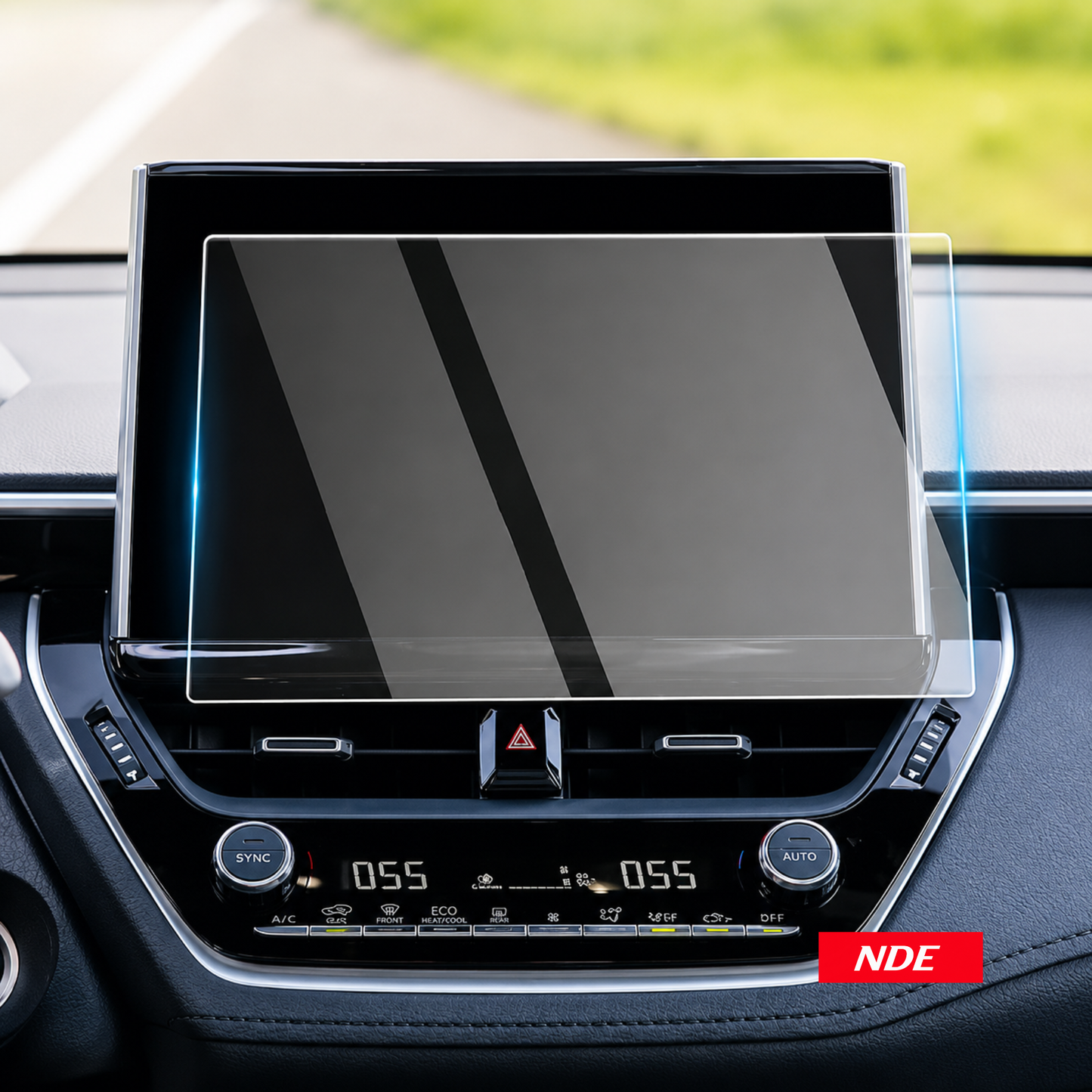 A clear screen protector with blue and green alignment labels is being applied to a car infotainment touchscreen by two hands inside a vehicle. Text at the top reads 'Easy To Stick & No Bubble' and a red badge at the bottom right says 'NDE'.